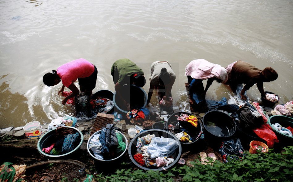 Middle age washing a step away from river