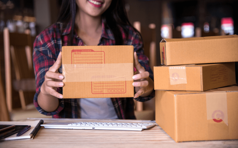 a girl holding a packed product representing amazon selling business idea