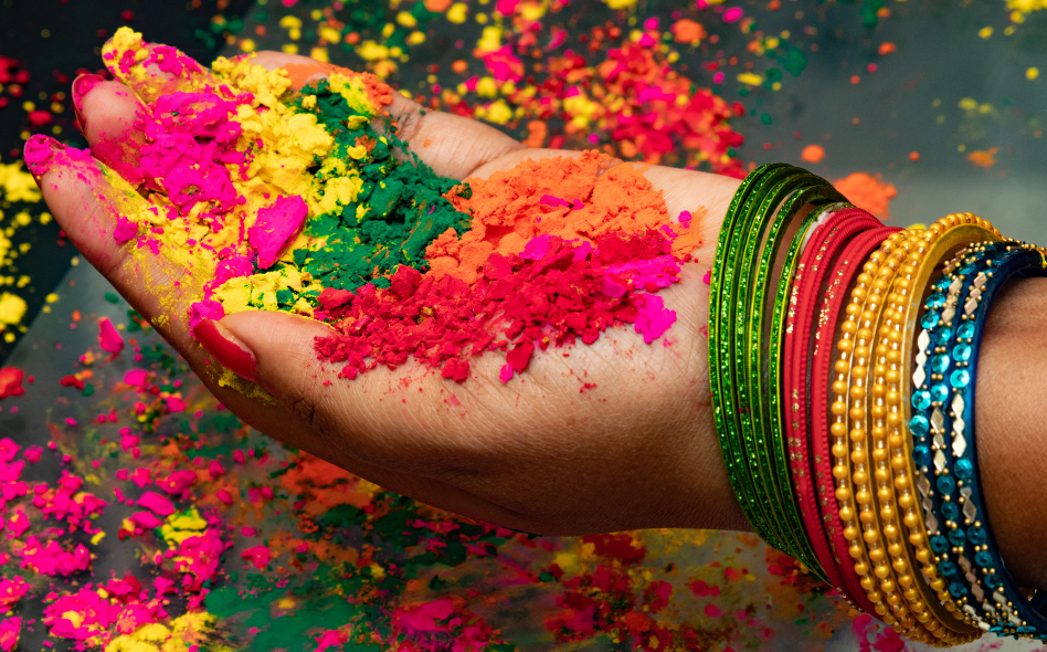 a hand with full of holi colour power