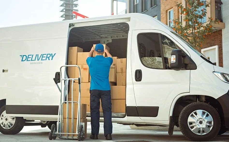 a delivery guy unloading the boxes from the van